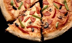 The cost of a slice shot up with the price of ingredients, but has yet to fall back to Earth as the economy has tanked.