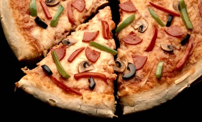 The cost of a slice shot up with the price of ingredients, but has yet to fall back to Earth as the economy has tanked.