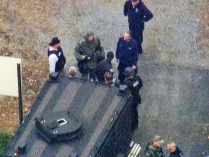 Chopper 4 video showed police leading a man in handcuffs out of the school building. Chopper 4 video showed police leading a man in handcuffs out of the school building.