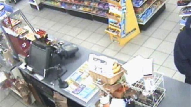 Police are looking for a robber accused of holding up a Flushing, Queens deli on Feb. 26. This video shows the suspect showing a gun as he robs the worker. Anyone with information is asked to contact Crime Stoppers at 800-577-TIPS or at nypdcrimestoppers.com