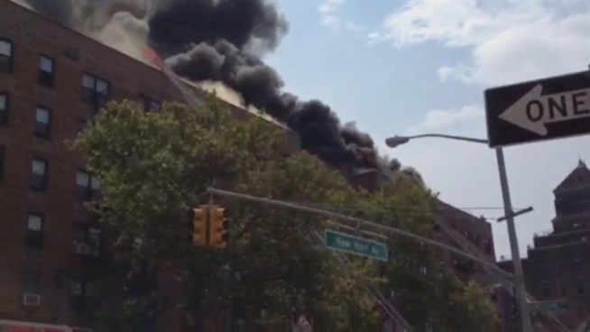 Check out this raw video of flames leaping from the roof of a Brooklyn building where firefighters battled a huge blaze Thursday.