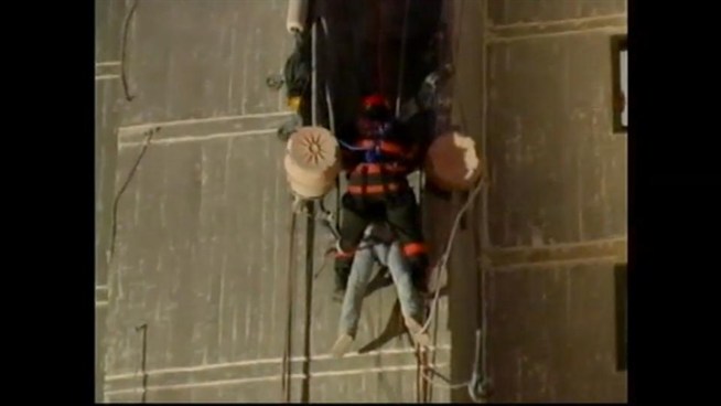 Using ropes to descend a hi-rise, hero firefighters say two workers stranded on a building.