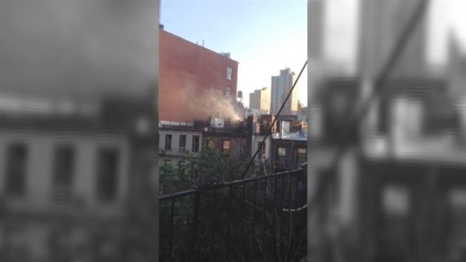 An NBC 4 New York viewer sent in this raw video of smoke billowing from the roof as firefighters battled a blaze that consumed an Upper East Side building Thursday morning.