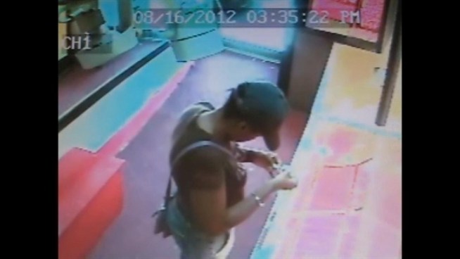Police released this surveillance footage in hopes the public could help identify of an alleged jewelry thief in the Bronx.  When someone from the store chases after the woman, two furry, little white dogs join the fray.