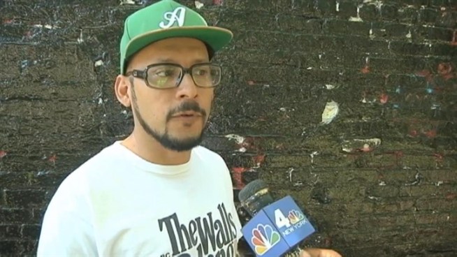 Two NYPD officers painted over a mural in Inwood of the word 