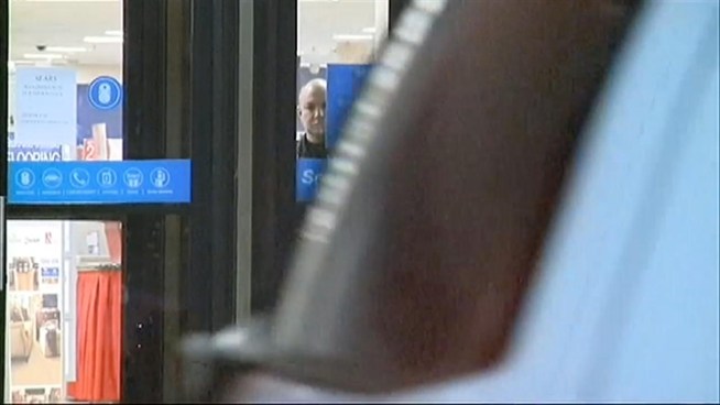A suspected shoplifter at a Woodbridge, N.J. mall was shot and killed by a township police officer after he grabbed and held a woman hostage when he was confronted by store security.