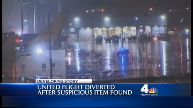 A United Airlines flight from Newark to Geneva was diverted to Logan International Airport in Boston because of a suspicious item found in an unclaimed seat Tuesday night, officials said. Andrew Siff reports live from Newark.