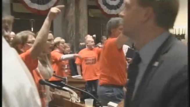 New Jersey Governor Chris Christie was called a 'liar' today by thousands of police officers and firefighters at a rally in Trenton today.   	New Jersey reporter Brian Thompson tells us about the battle between public employee unions and politicians over budget cuts and pension changes.