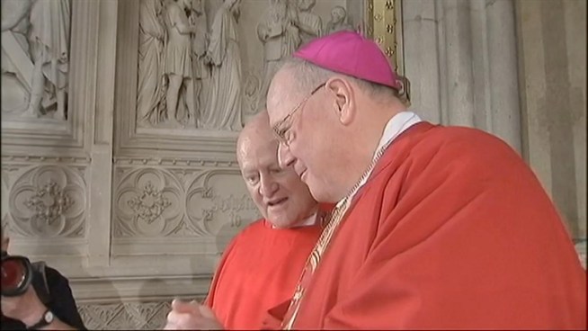 Archbishop Timothy Dolan light St. Patrick's first virtual candle on an iPad Thursday. (June 29, 2011)