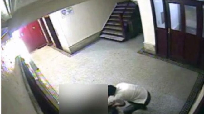 Police are looking for the suspect seen on surveillance video walking up behind the victim in a building lobby and punching her in the head.