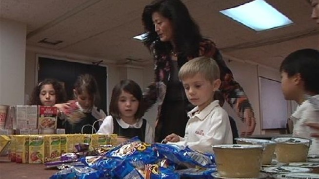 Students from the Geneva School of Manhattan give up their after-lunch playtime to pack snack bags for the preschoolers at Bushwick United Head Start and five other Head Start schools as part of the 
