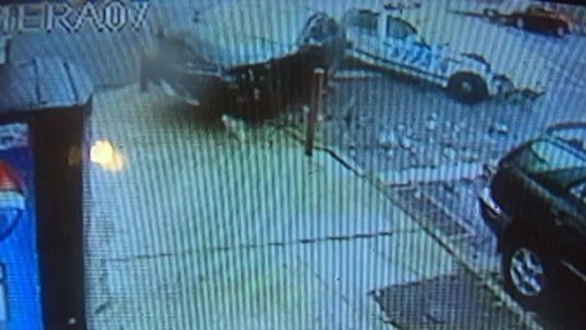 Surveillance video shows two police cars colliding at a Brooklyn intersection Tuesday evening.