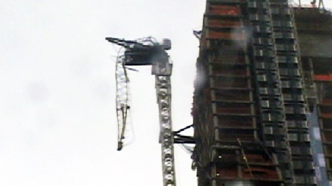 A construction crane atop luxury condo building 157 West 57th Street, between 6th and 7th avenues, collapses amid fierce winds Monday, Oct. 29.