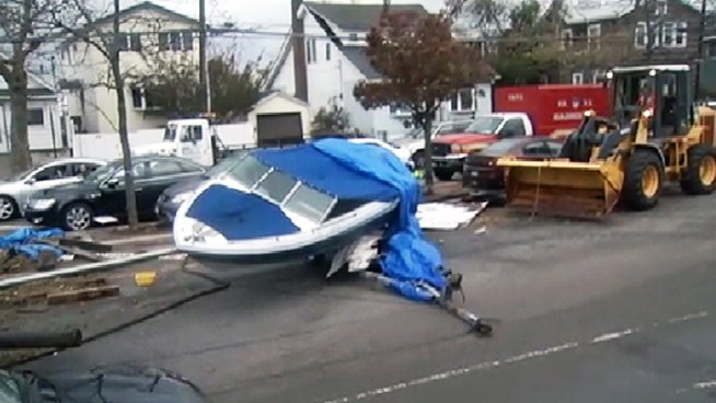 Fierce winds and surging waters swept boats into the street on Cross Bay Boulevard in Broad Channel, connecting Howard Beach and Rockaway Beach in Queens. Andrew Siff reports.