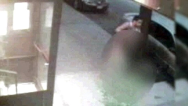 Surveillance video showed the suspect dragging an 85-year-old woman down the street early Monday morning.