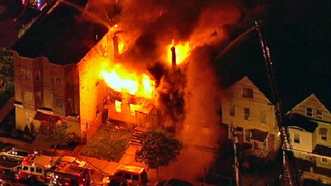 Buildings were evacuated on a block in Elizabeth, N.J, where firefighters battled a massive fire Tuesday night. This is raw chopper video over the scene.
