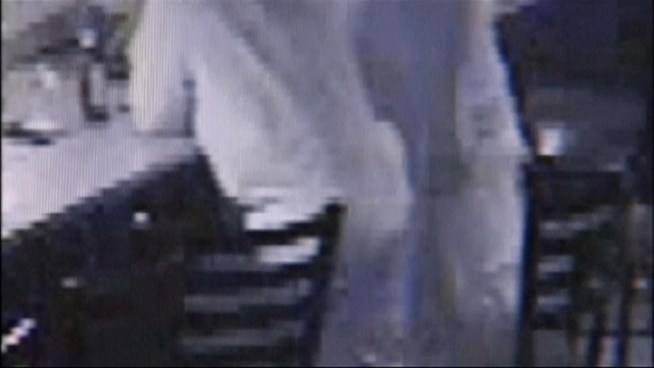 A Nassau County police officer was caught on tape pointing his gun at a worker inside a Farmingdale bar.