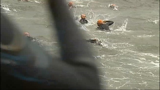 Swimmers dive into the Hudson River Sunday in the 2011 Nautica New York City Triathlon.