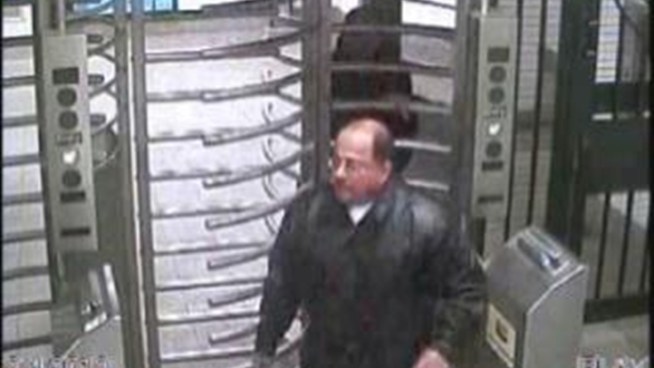 Two men pretending to be police officers assaulted and robbed a man in a Delancey Street subway station when he threatened to call the cops, authorities say.