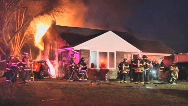 A pickup truck crashed into a home in Selden on Long Island Tuesday, sparking a large fire. Police have arrested the driver.