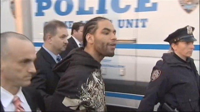 Tempers flare outside of police precinct as accused cop shooter Luis Ortiz walks out to be greeted by his family and friends. Ida Siegal reports.