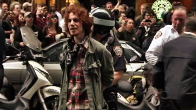 At least 10 people are arrested as hundreds of Wall Street protesters clash with police in a mass demonstration after Brookfield Properties  tells the city to postpone the Zuccotti Park clean-up.