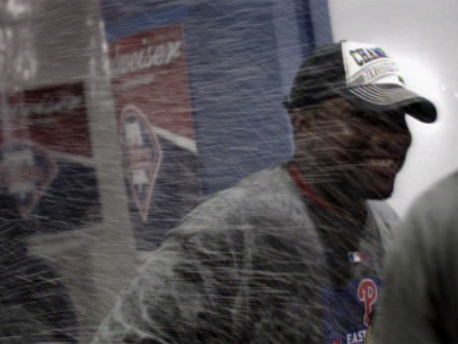 The Phillies celebrate their NL East title win with bubbly in the locker room.