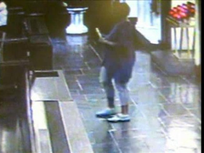 A woman is caught on tape allegedly stealing a purse from a house of worship.