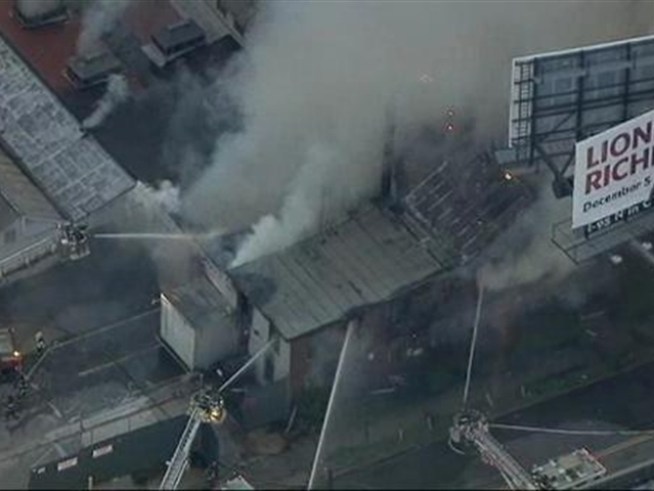 Three-alarm fire rages in Queens warehouse.