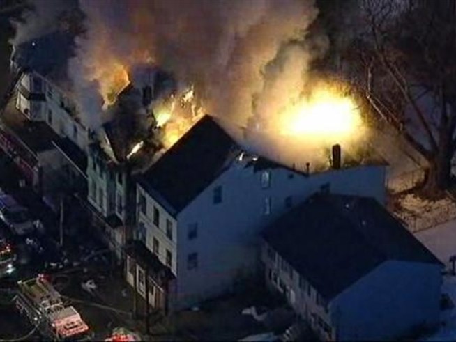 A three-alarm fire consumed multiple buildings in <a title=
