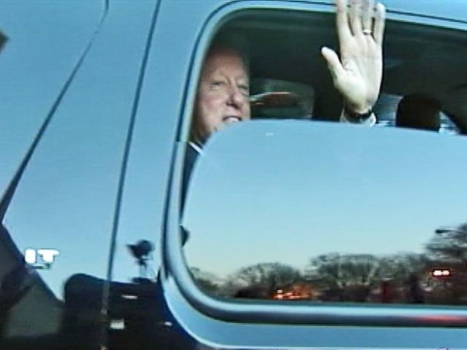 Former President Bill Clinton offers a smile and a wave as he leaves the hospital following a heart procedure.