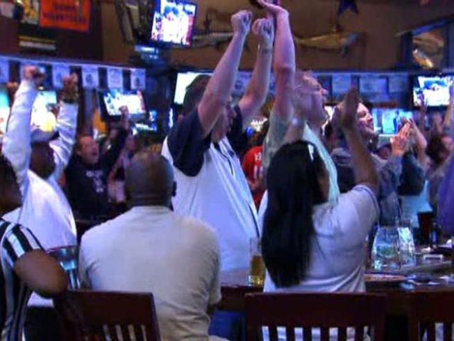 Fans at a watch party at Humperdinks Sports Bar in Arlington cheer at the Texas Rangers' Game 5 victory.