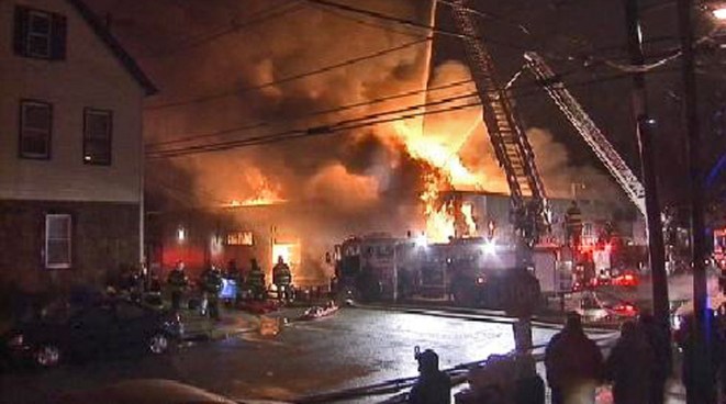 A seven-alarm fire broke out Tuesday morning at an auto repair shop in Elizabeth, N.J.