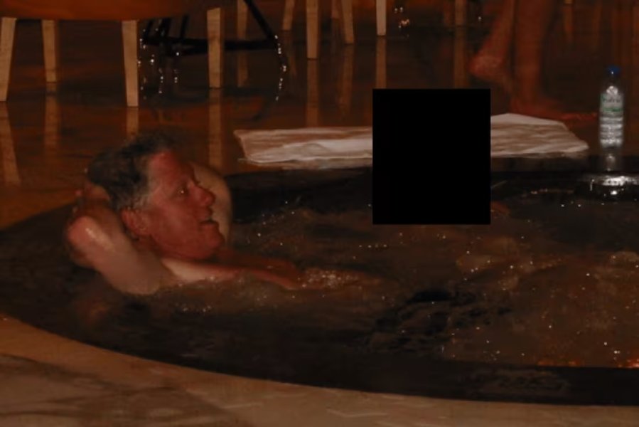 Photo appears to show Bill Clinton in a hot tub next to a person whose face has been redacted.