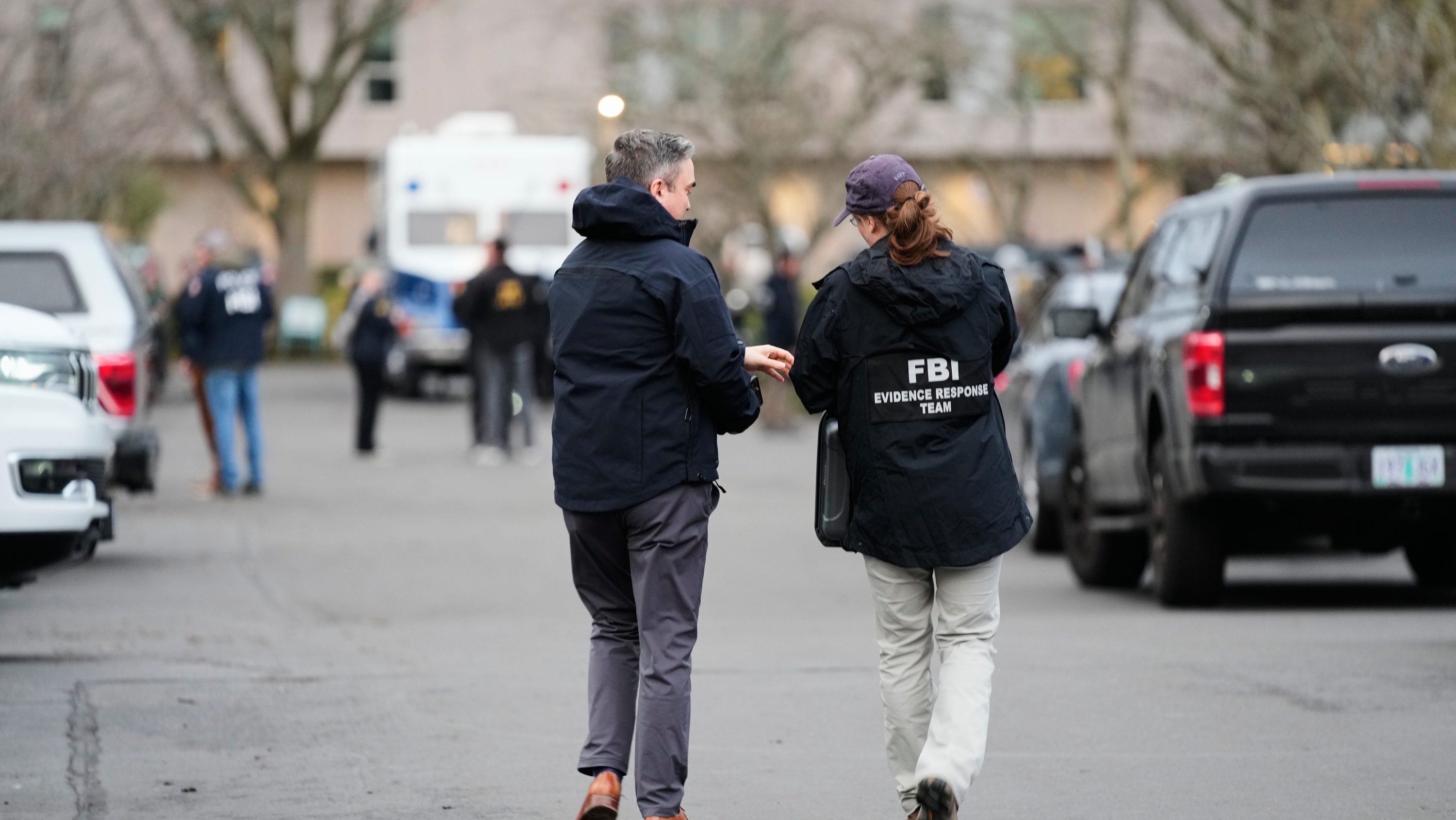Law enforcement officials work the scene following reports that federal immigration officers shot and wounded people in Portland, Ore.