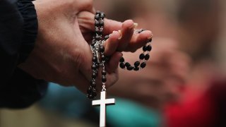 Woman Holding Rosary Beads