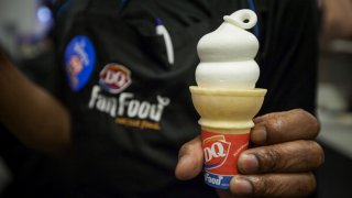 In this May 28, 2014, file photo, a Dairy Queen employee displays an ice cream cone for a photograph at a DQ Grill & Chill restaurant ahead of its grand opening in the Manhattan borough of New York.