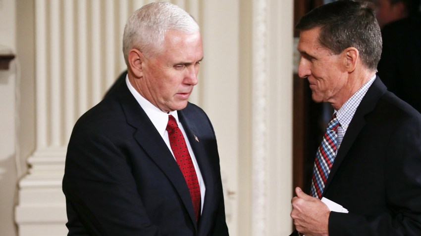 Vice President Mike Pence (L) shakes hands with then-National Security Adviser Michael Flynn at the White House on Feb. 10, 2017, in Washington.