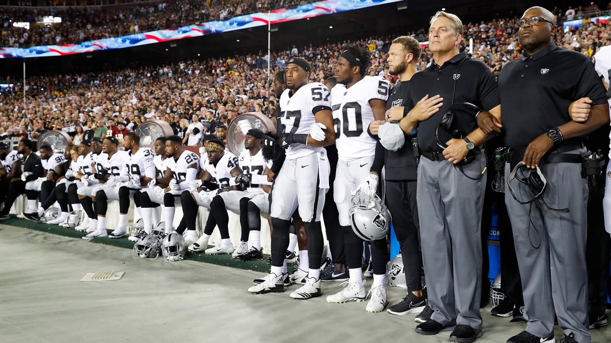 Some members of the Oakland Raiders sit on the bench during the national anthem before an NFL football game against the Washington Redskins in Landover, Maryland, Sunday, Sept. 24, 2017.