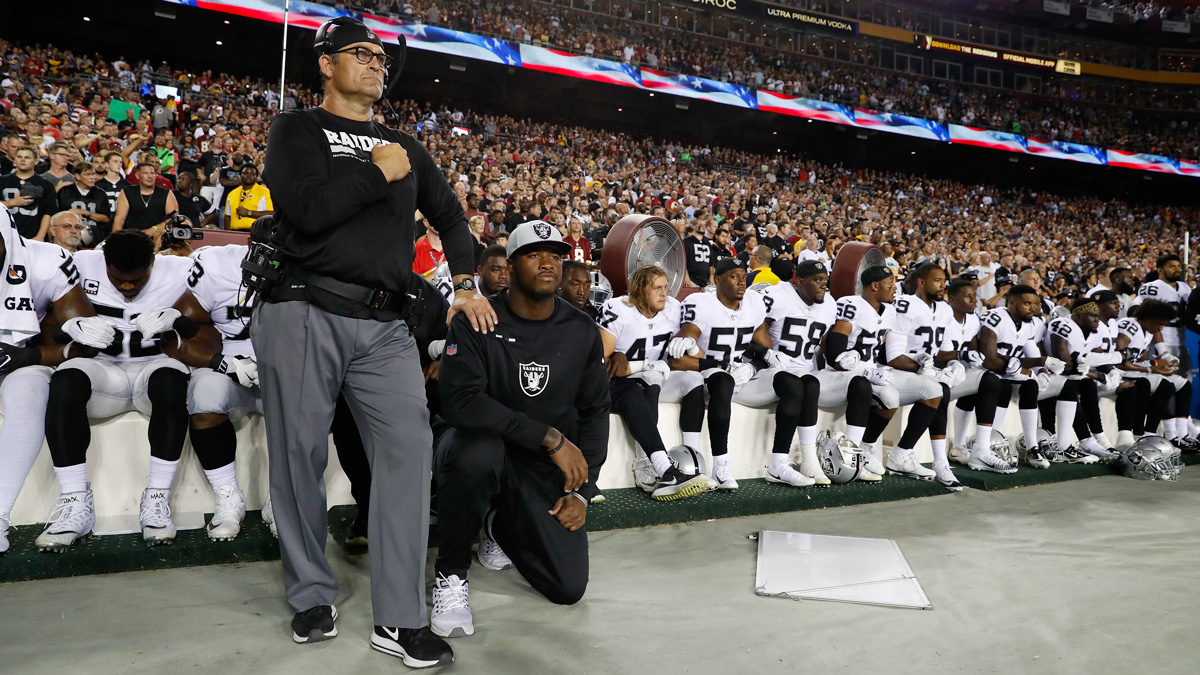 Some members of the Oakland Raiders kneel during the playing of the national anthem before an NFL football game against the Washington Redskins in Landover, Maryland, Sunday, Sept. 24, 2017.