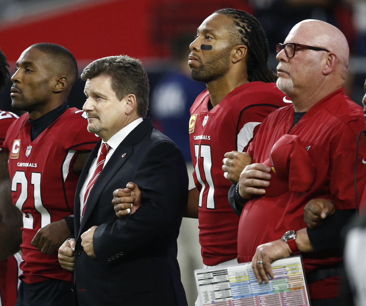 From left; Arizona Cardinals cornerback Patrick Peterson, president Michael Bidwill, wide receiver Larry Fitzgerald and head coach Bruce Arians stand during the national anthem prior to an NFL game against the Dallas Cowboys, Monday, Sept. 25, 2017, in Glendale, Ariz.