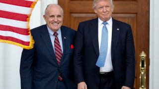 In this Nov. 20, 2016, file photo, then-President-elect Donald Trump, right, and former New York Mayor Rudy Giuliani pose for photographs as Giuliani arrives at the Trump National Golf Club Bedminster clubhouse in Bedminster, N.J..