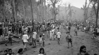 islanders enter a refugee camp in Guam during World War II