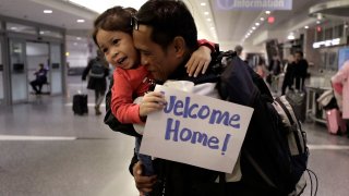 Thy Chea hugs his daughter