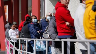 People wait in line for help with unemployment benefits at the One-Stop Career Center, Tuesday, March 17, 2020, in Las Vegas. Nevada Department of Employment, Training and Rehabilitation and its partner organizations, like the One-Stop Career Center, have seen an increase in traffic due to the coronavirus.