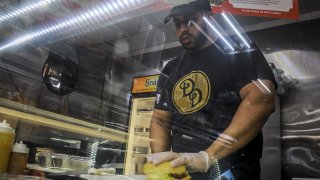Bodega owner stands behind counter