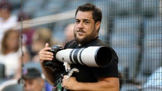 In this Aug. 2, 2016, photo provided by Christopher Pasatieri, New York Post photographer Anthony J. Causi is shown before a New York Mets baseball game in New York. Causi, a highly skilled and exceedingly popular sports photographer for The New York Post who covered the city’s teams for 25 years, died Sunday, April 12, 2020, from the new coronavirus