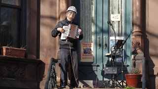 musician stands on his porch