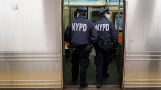 police officers enter subway