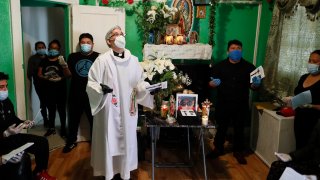 priest stands in living room